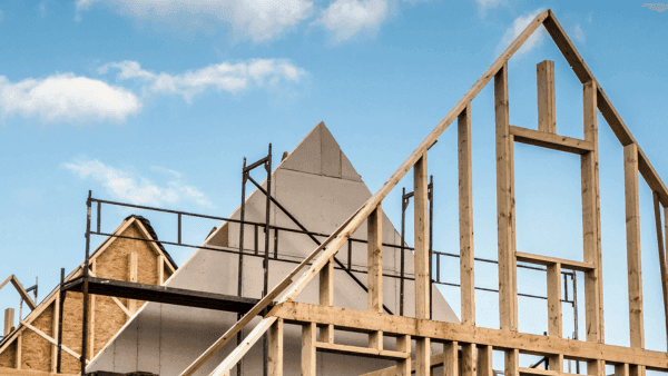 A house under construction with wooden framing